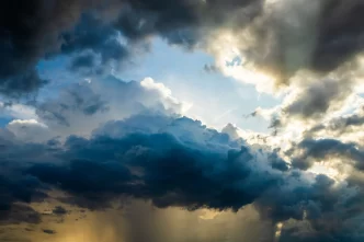 Cielo nuvoloso con raggi di sole che penetrano attraverso le nuvole.