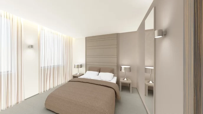 Camera moderna in hotel urbano con letto matrimoniale, arredi eleganti e colori neutri.