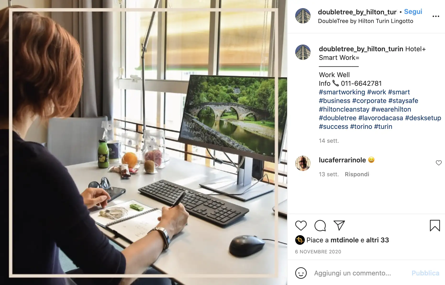 Persona che lavora in smart working in un hotel DoubleTree by Hilton, con scrivania ben organizzata e computer.