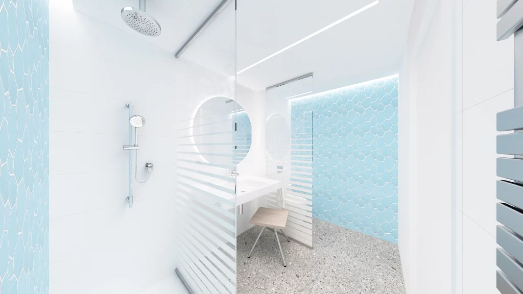 Bagno moderno di un hotel con doccia a pioggia, piastrelle esagonali azzurre, lavabo bianco con specchio rotondo e pavimento in granito chiaro.